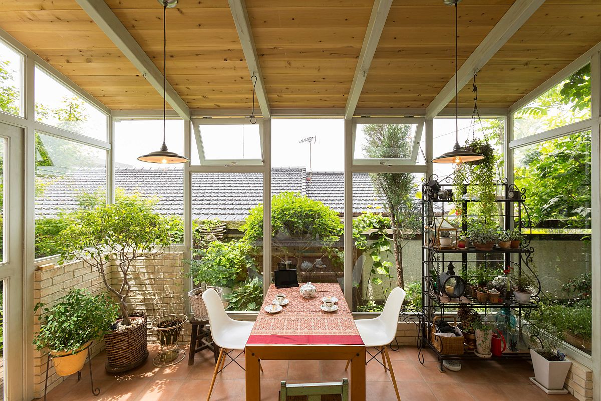 Greenery brings freshness and natural beauty into the spacious farmhouse style sunroom