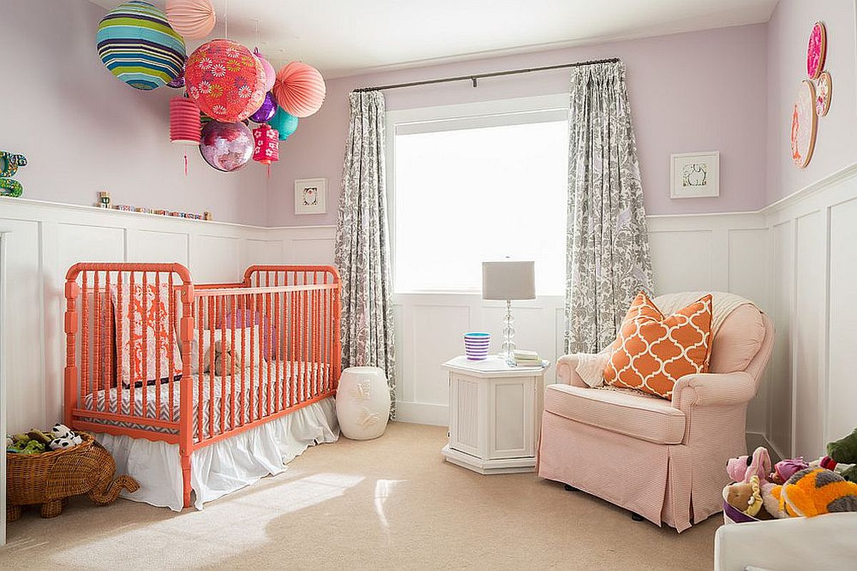 It is the crib and throw pillow that bring bright coral brilliance to this modern white nursery