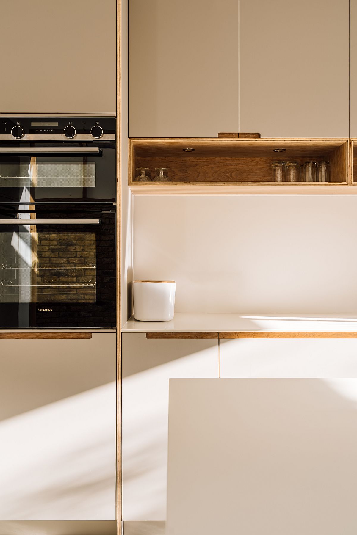 Kitchen cabinets in plywood with neutral hues along with warm oak accents