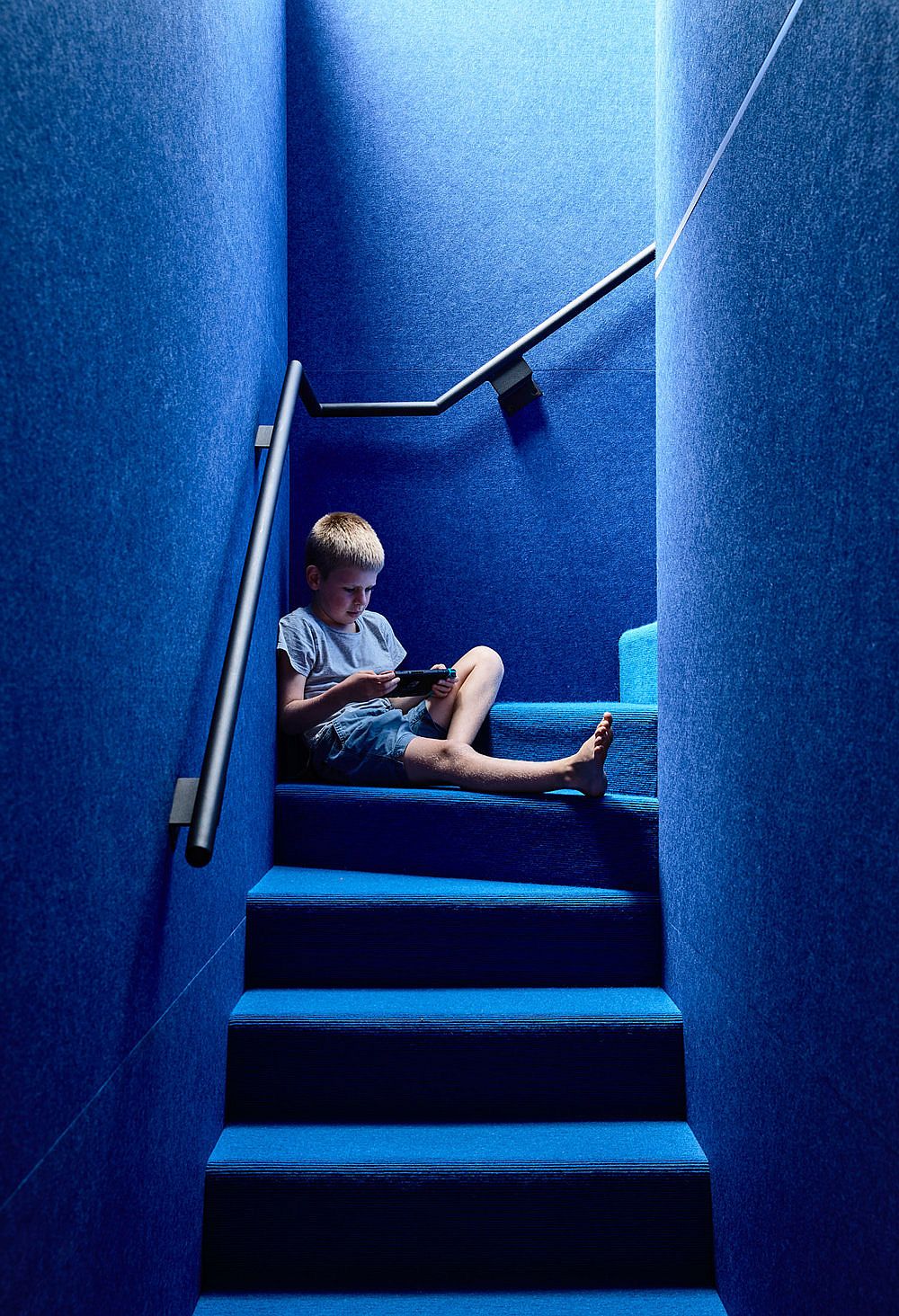 Light well illuminates the blue stairway in a fabulous manner