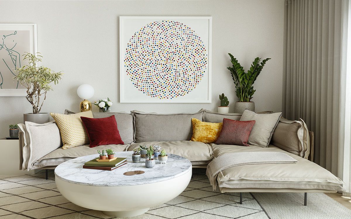 Low-slung sectional in white coupled with gorgeous wall art and a custom coffee table