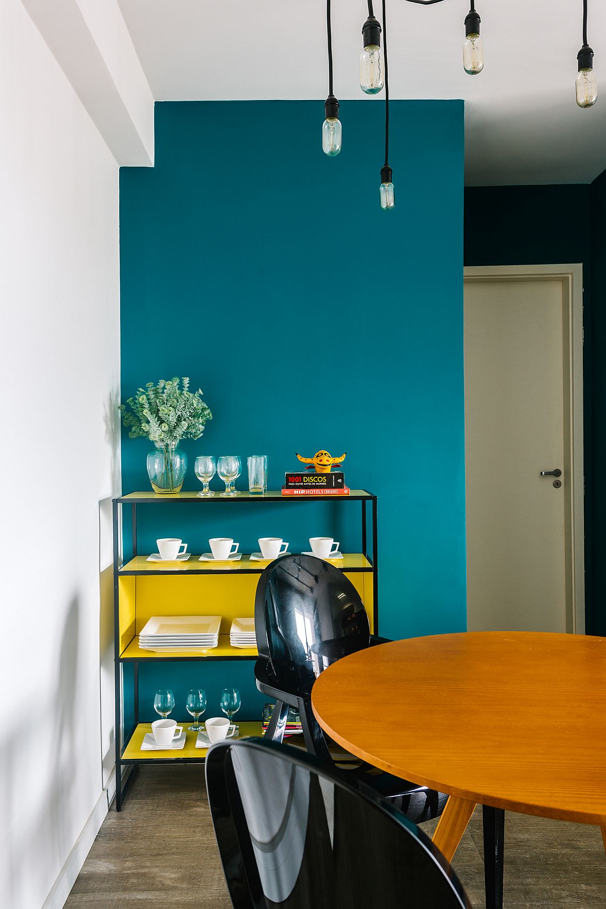 Minimal industrial-style Edison bulb lighting for the dining area next to the living space