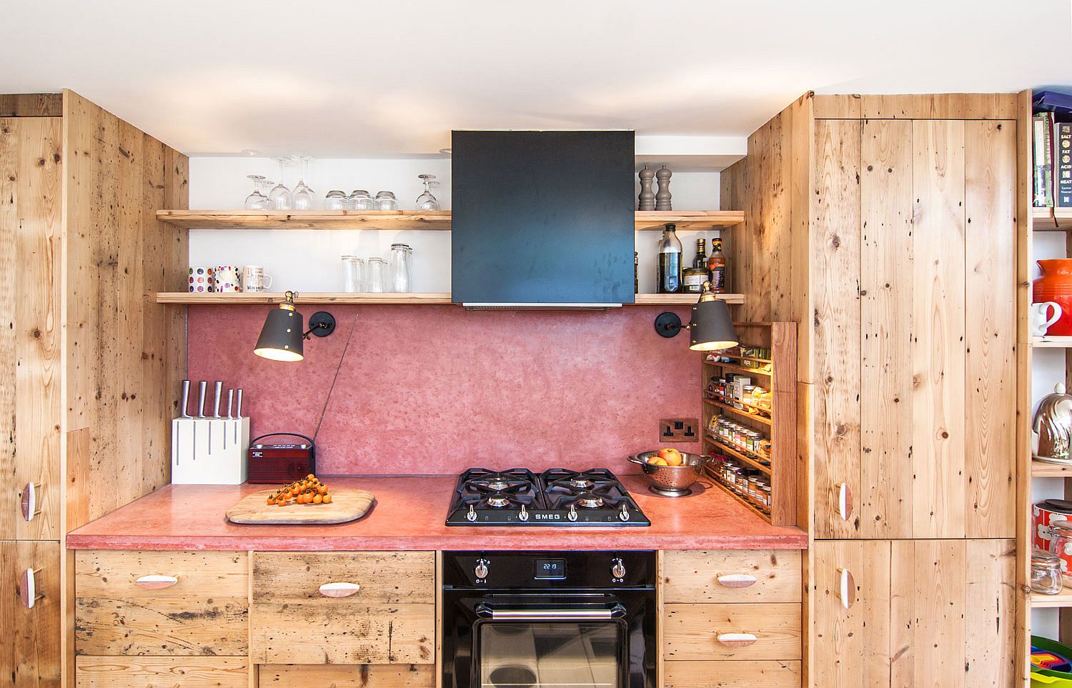 Modern eclectic kitchen with custom concrete worktop and backsplash in red