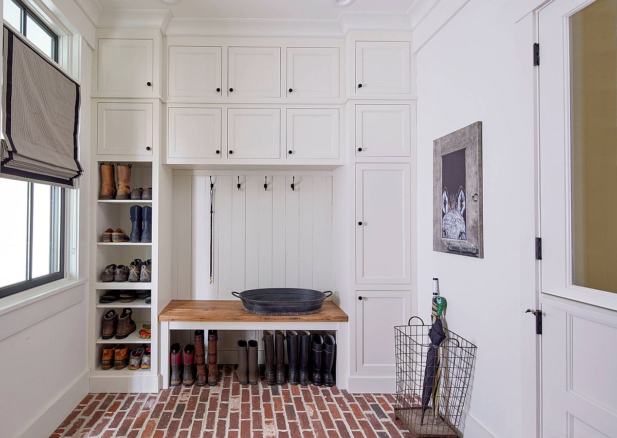 Modern farmhouse entry room with white walls and beautiful brick floor