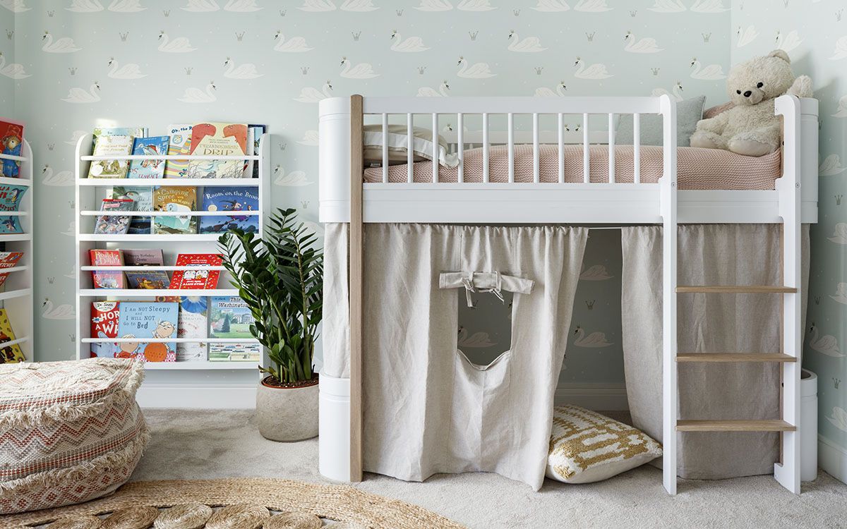 Modern kids' room with bunk bed that has playarea underneath and bookshelves next to it