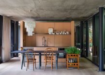 Open-and-elegant-dining-area-of-the-Rio-home-with-spacious-ambiance-raw-concrete-ceiling-and-wooden-cabinets-92650-217x155