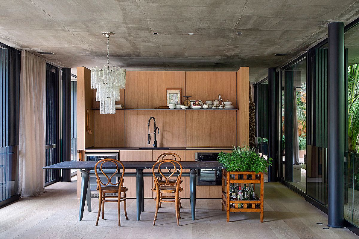 Open-and-elegant-dining-area-of-the-Rio-home-with-spacious-ambiance-raw-concrete-ceiling-and-wooden-cabinets-92650