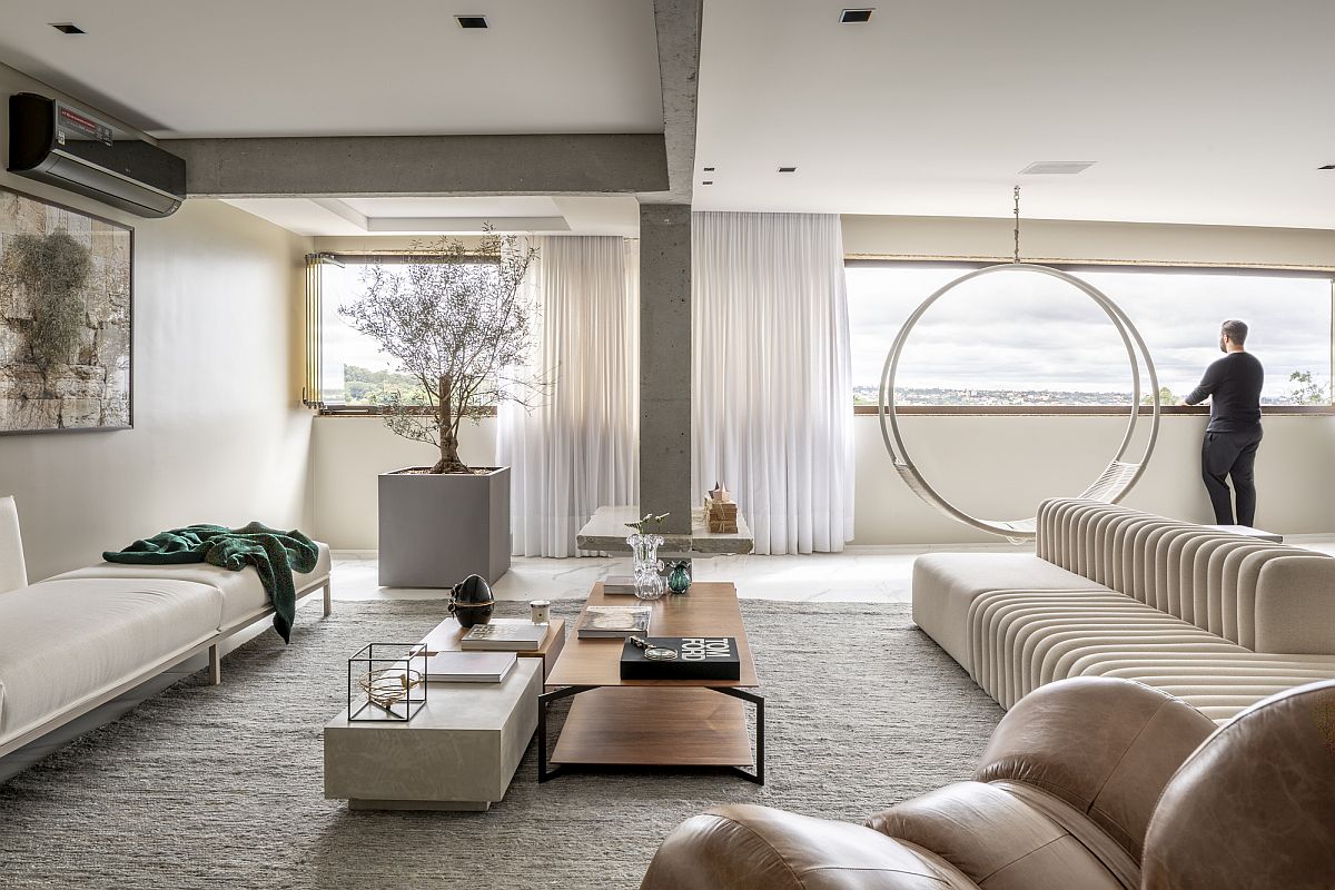 Polished contemporary living room of the Brazilian apartment in white with swing chair Pêndulo by Ruy Ohtake