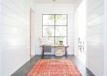 Rug-adds-bright-orange-hue-to-the-neutral-modern-entry-that-has-white-walls-and-dark-gray-brick-floor-39400-217x155