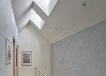 Series-of-skylights-on-the-upper-level-bring-ample-natural-light-into-the-minimal-multi-level-interior-96703-217x155