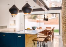Skylight-glass-doors-bring-natural-light-into-this-kitchen-and-dining-area-while-Tom-Dixon-pendants-take-over-after-sunset-33544-217x155