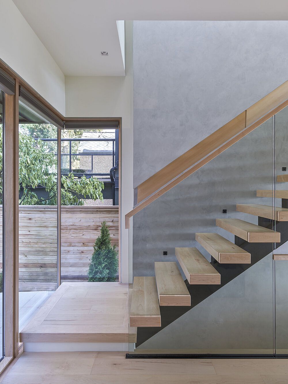 Sleek and stylish glass and wood staircase inside the house with modern design