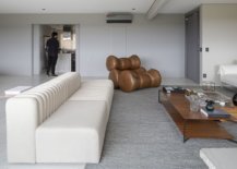 Sleek-contemporary-sofa-in-white-coupled-with-a-unique-relaxing-chair-in-brown-64203-217x155