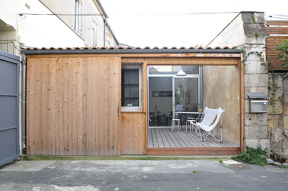 Sliding-wooden-doors-of-the-garage-replace-the-traditional-metallic-exterior-of-the-garage-turned-into-small-home-22535