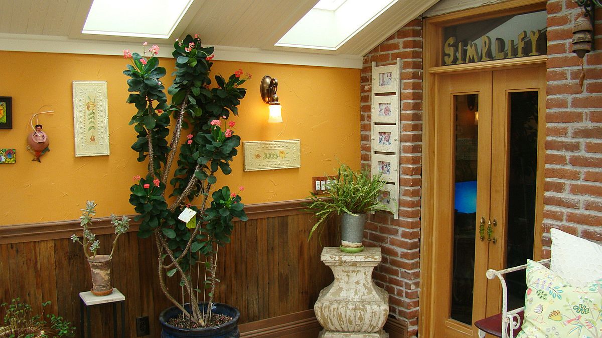 Small farmhouse style sunroom with lovely brick walls and ample natural light