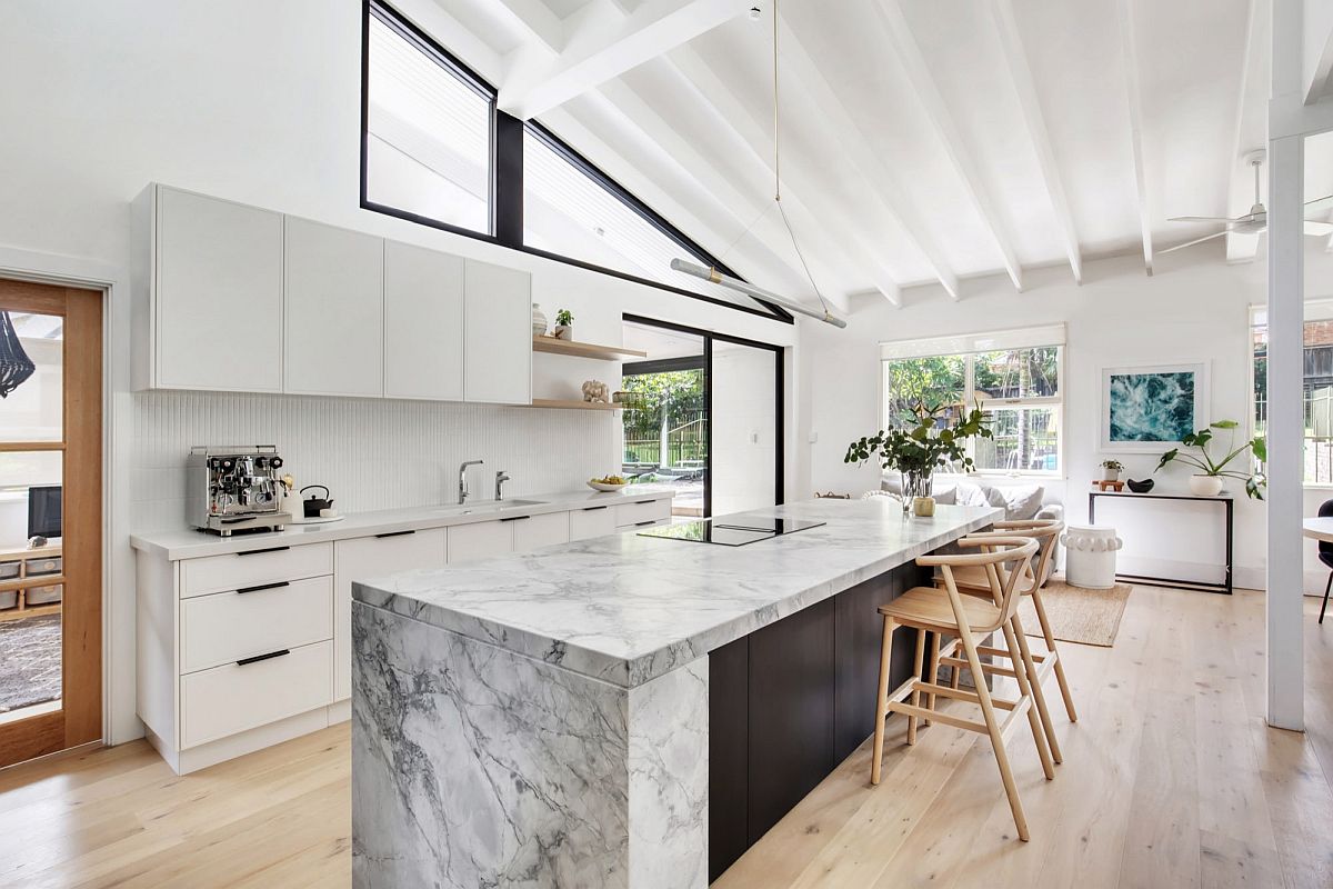 Spacious modern kitchen in white finds innovative ways to connect the interior with the outdoors