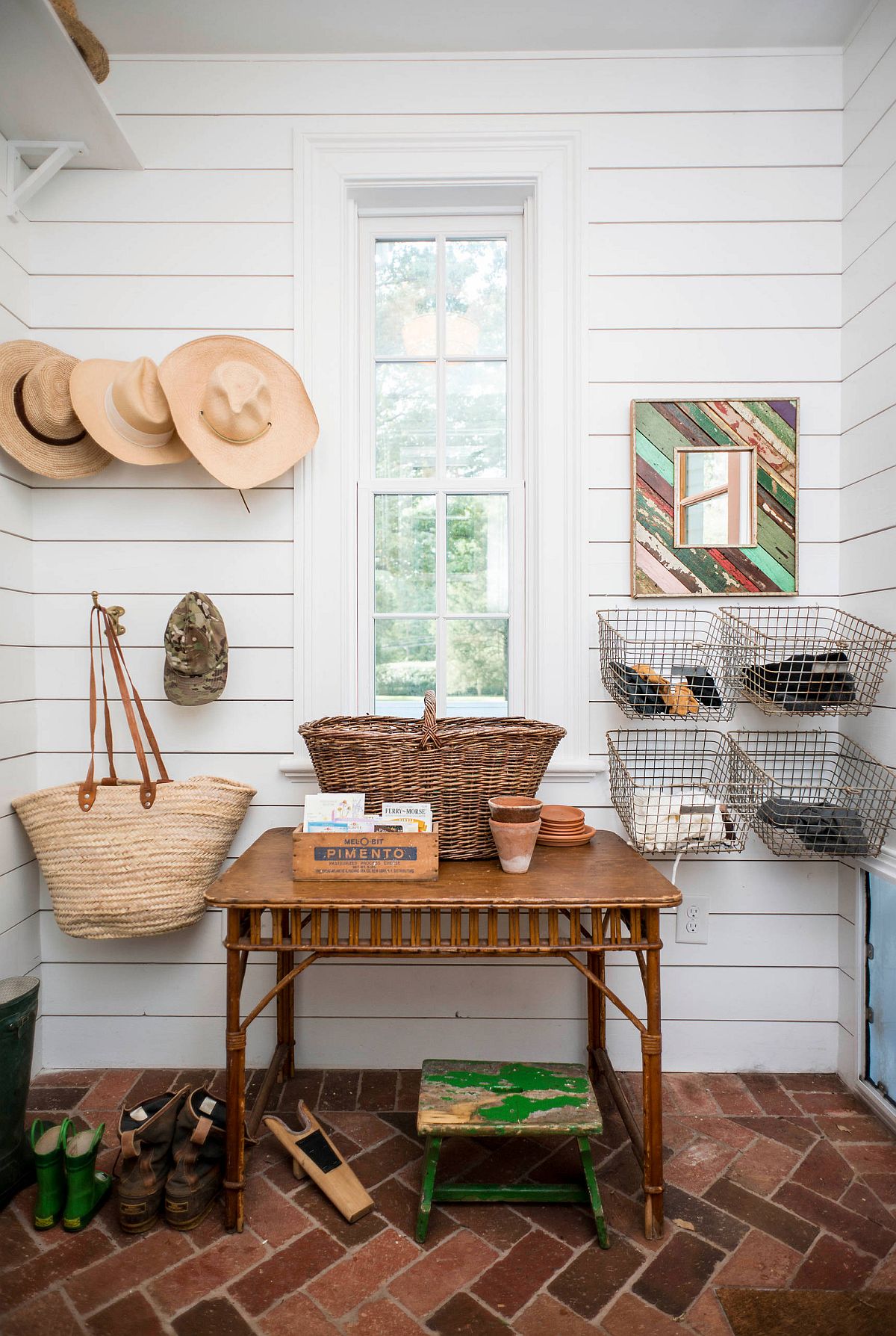 Stylish modern farmhouse entry room with white walls and a lovely brick floor