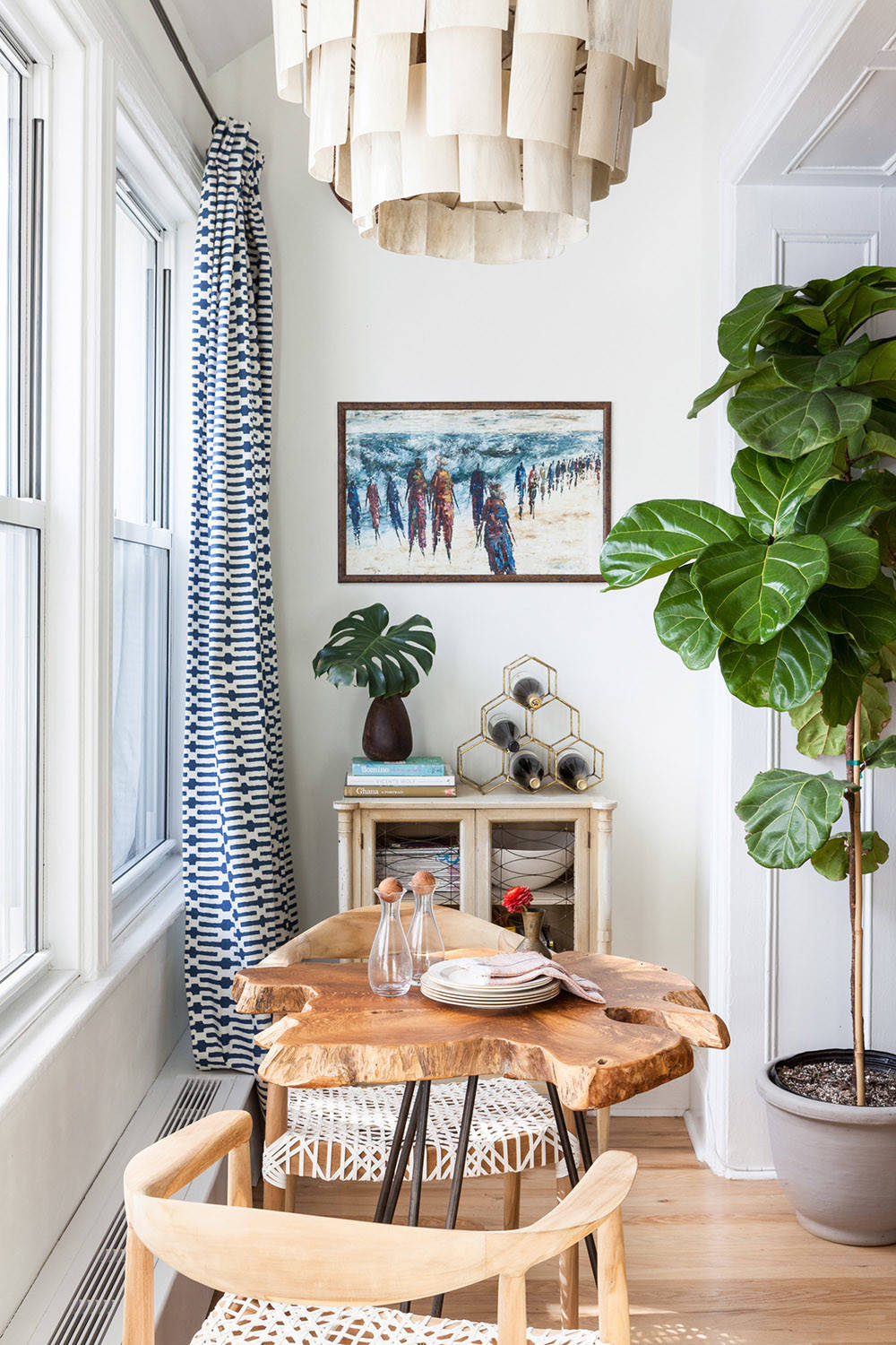 Tiny eclectic dining space inside the small NYC apartment that offers a view of the city skyline outside