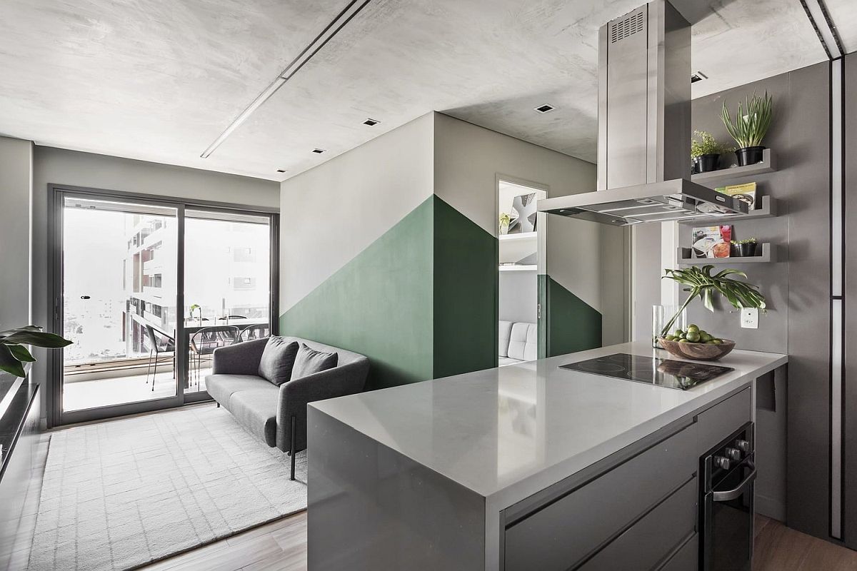 Use of green along with burnt cement creates a modern industrial style in the chic Sao Paulo Apartment