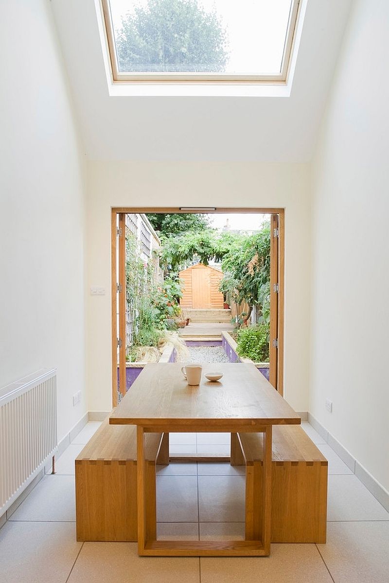 View of the outdoor space and garden from the dining room of the slim home