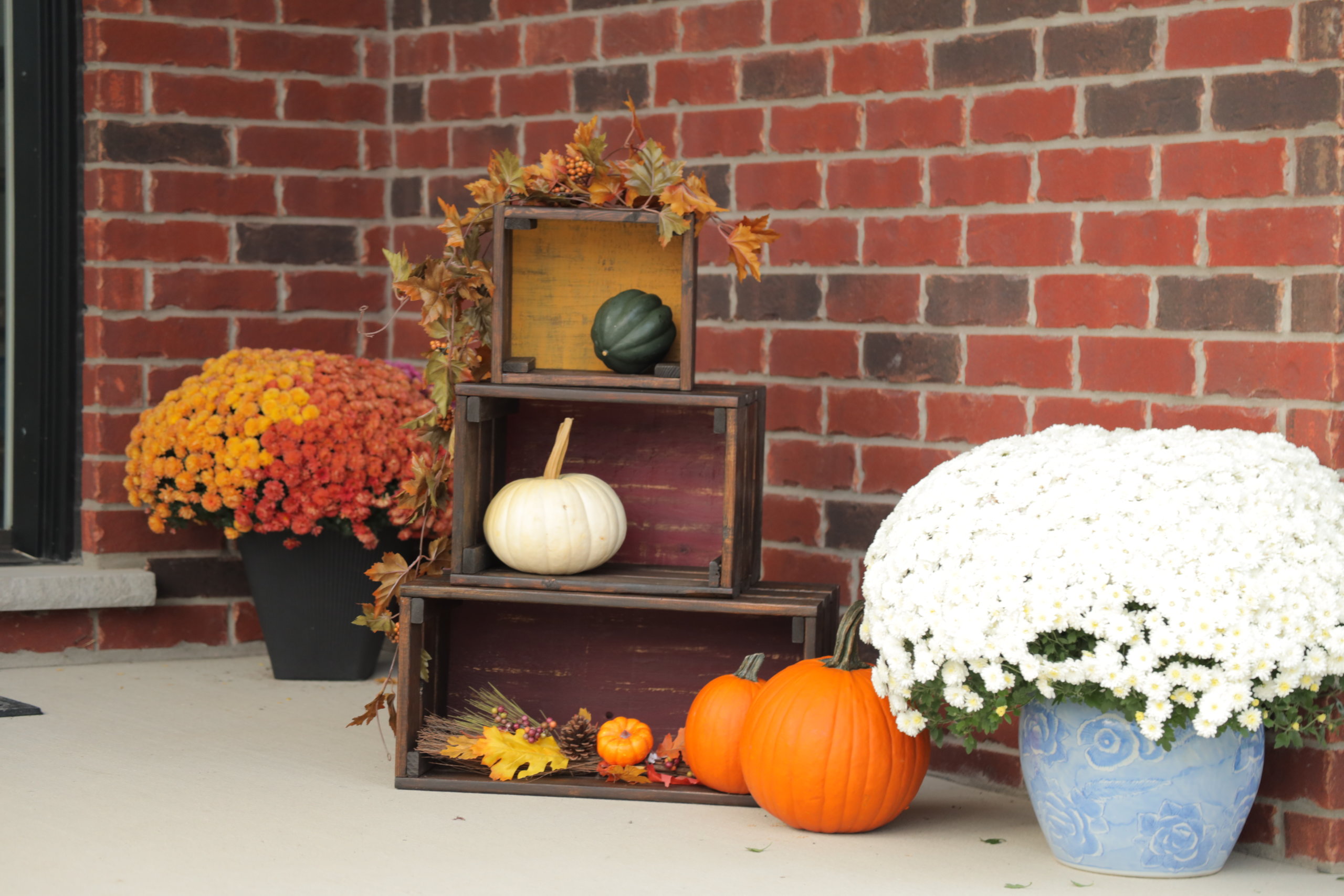 wood crates with pumpkins and flowers