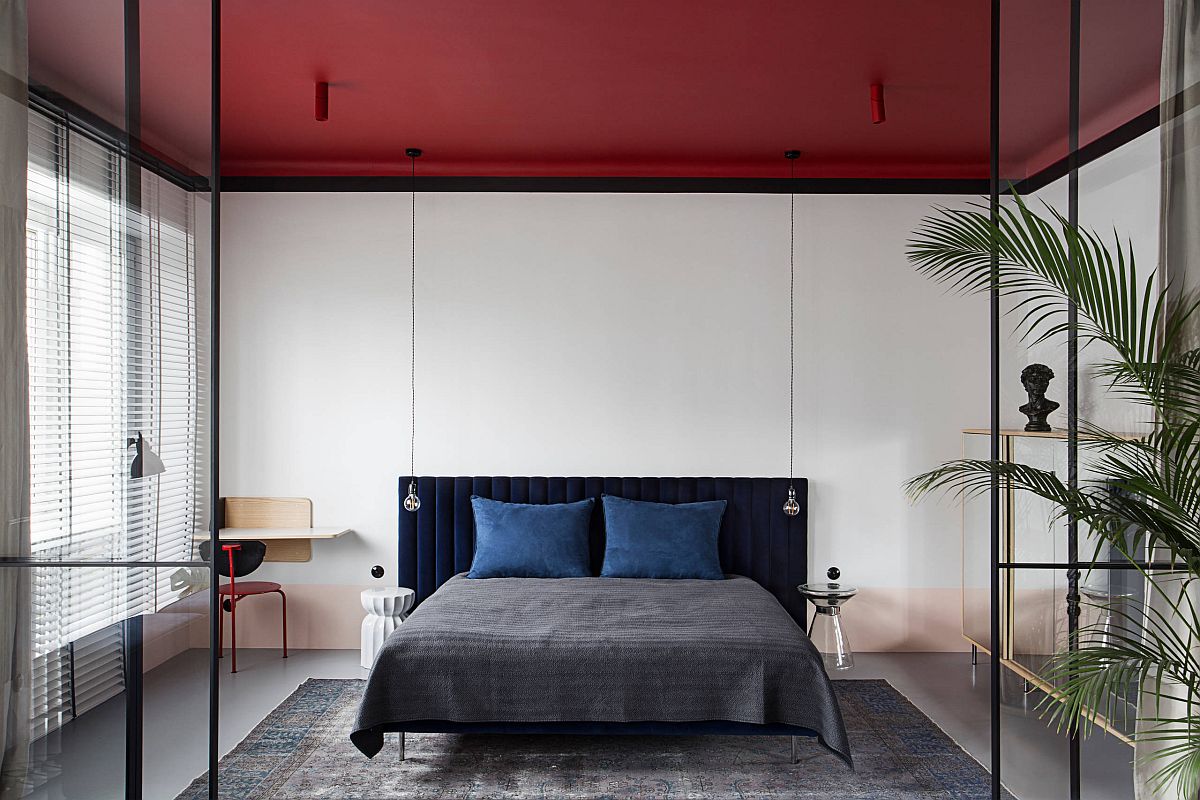 Brilliant red ceiling steals the spotlight in this small white bedroom