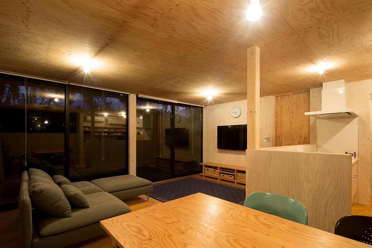 Cleverly placed recessed lights take over after sunset in the living room