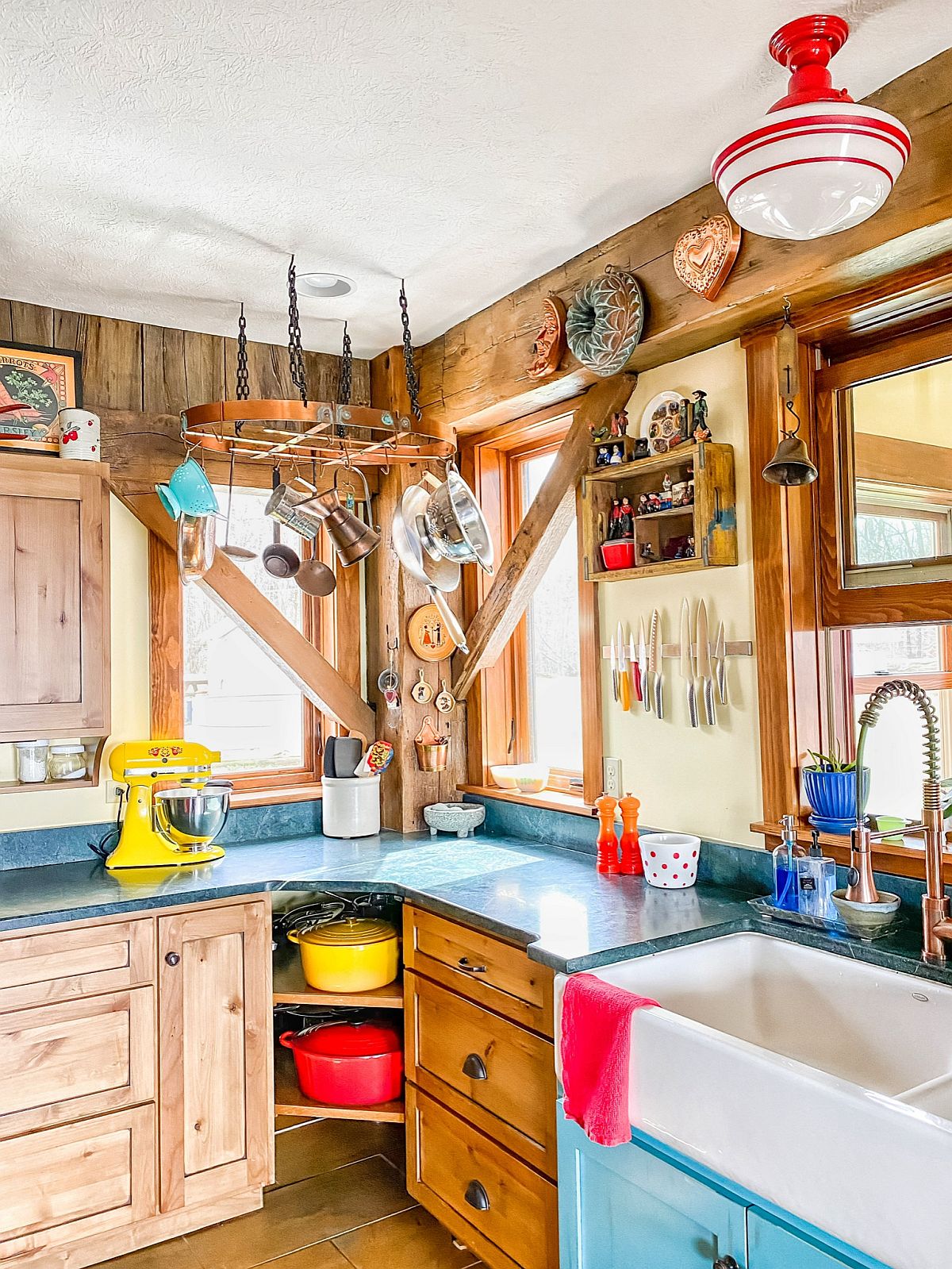 Countertops, kitchenware and accesories bring color to this small farmhouse style kitchen