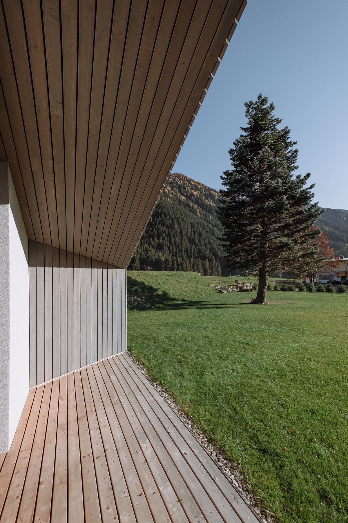 Covering over the house in vertical sawn-rough boards provides shade to the home during hotter months