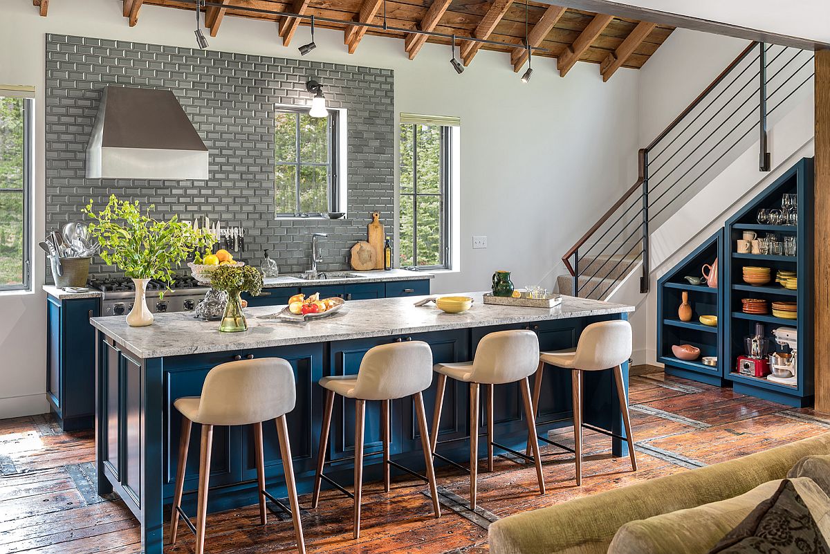 Custom blue kitchen island along with blue cabinets and stone countertops for the modern farmhouse style kitchen