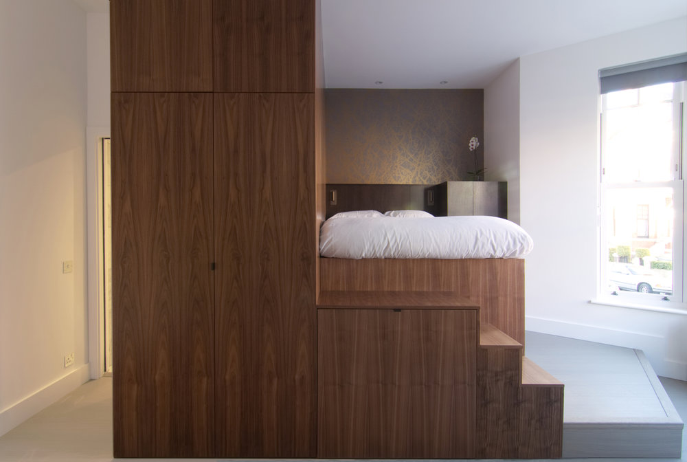 Custom wooden unit inside the apartment brings different functionalities to the ultra-small bedsit