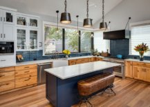 Dark-bluish-gray-is-a-popular-color-in-the-modern-farmhouse-kitchen-with-wooden-floors-and-cabinets-52485-217x155