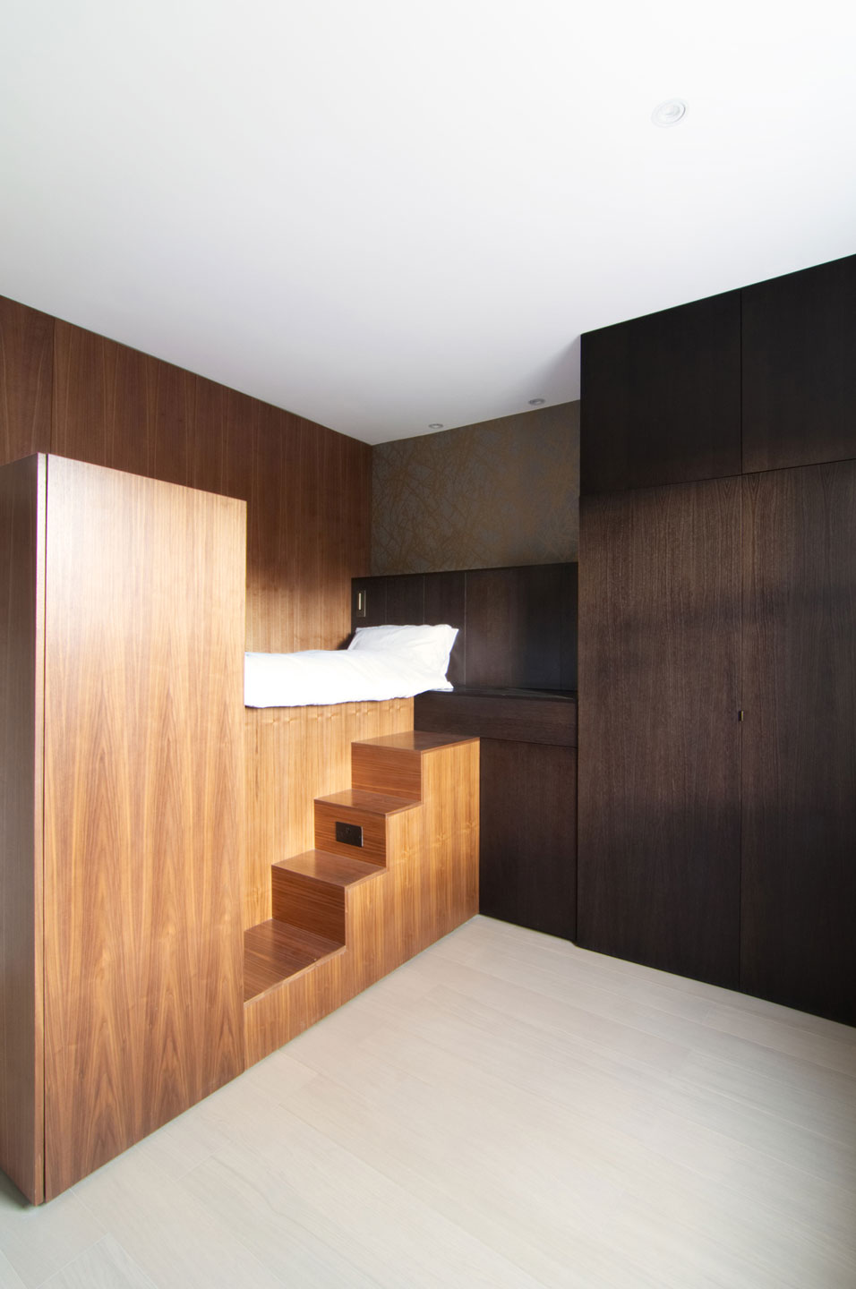 Each of the 18 sqm small apartments has a smart layout that depends on custom wooden structure
