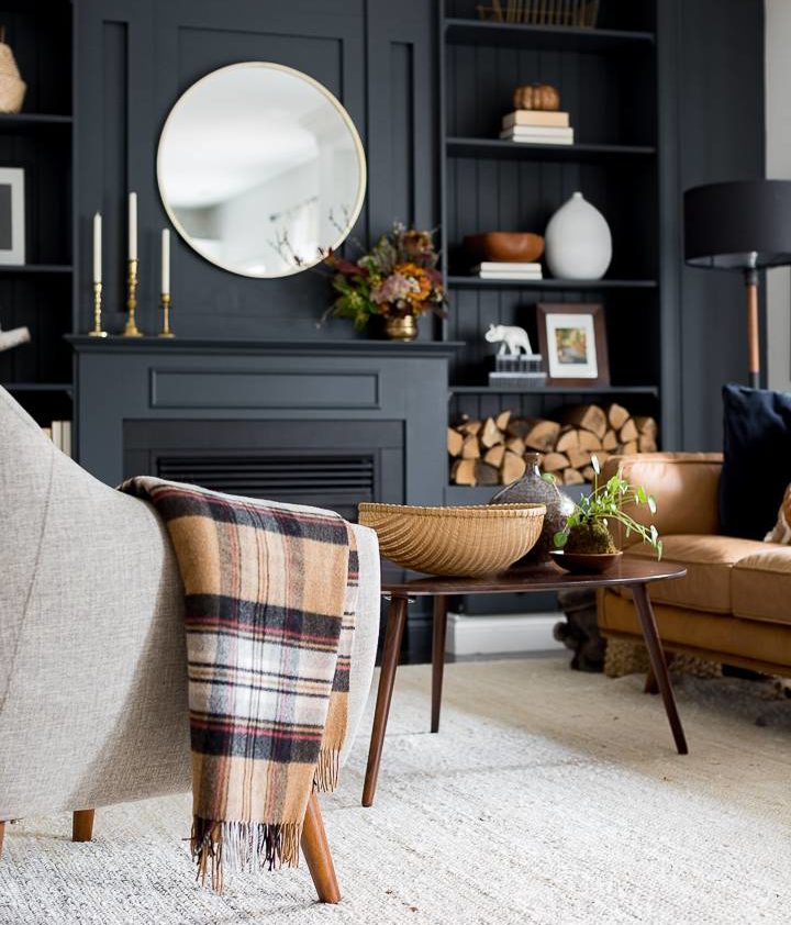 black fireplace surrounding with brown furniture and decor accents