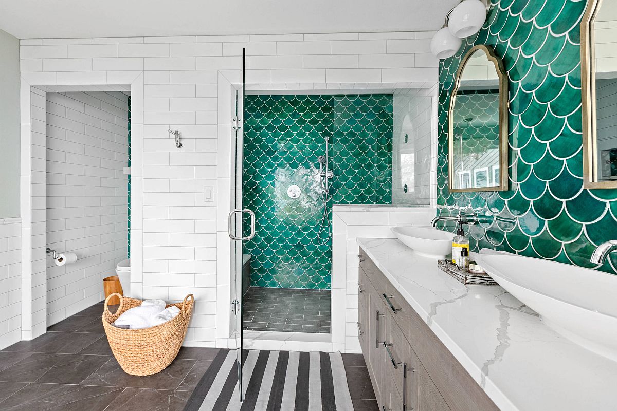 Gorgeous green tiles of the accent wall add to the beach style of this bathroom