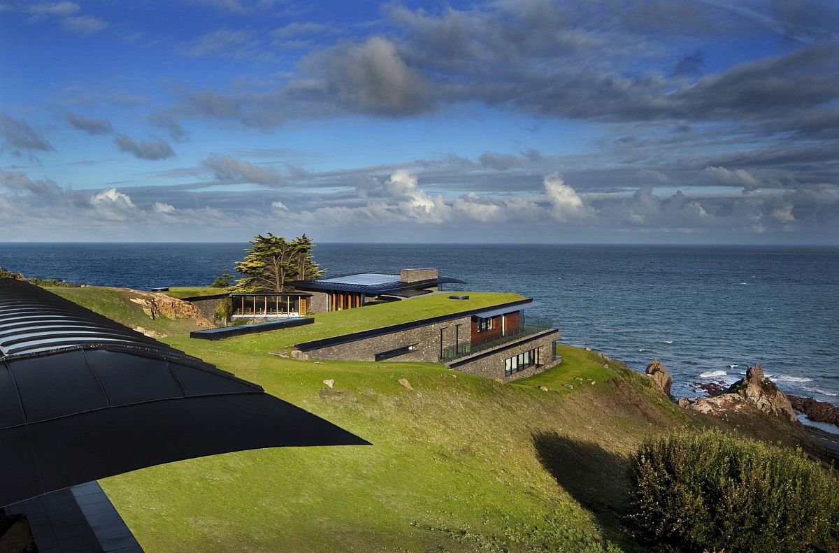 Lovely green roof blends the home seamlessly into the coastal landscape