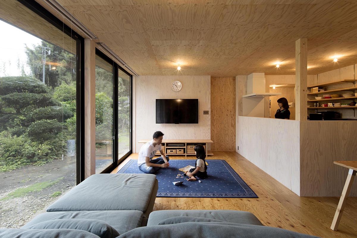 Lovely woodsy living area and kitchen of the house with sliding glass doors that connect it to the outdoors