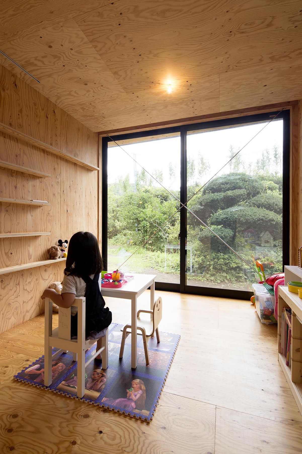 Minimal playroom of the modern Japanese home with sliding glass doors