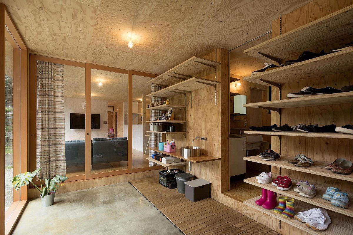 Open wooden shelves of the entry hold everything from the footwear to smart decorative pieces
