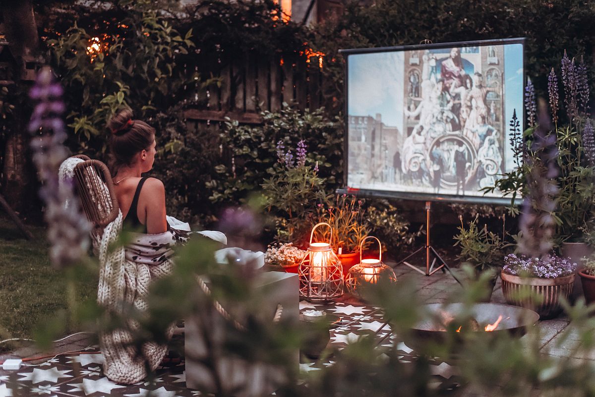 Outdoor lights, lanterns and greenery add to the ambiance of the garden cinema