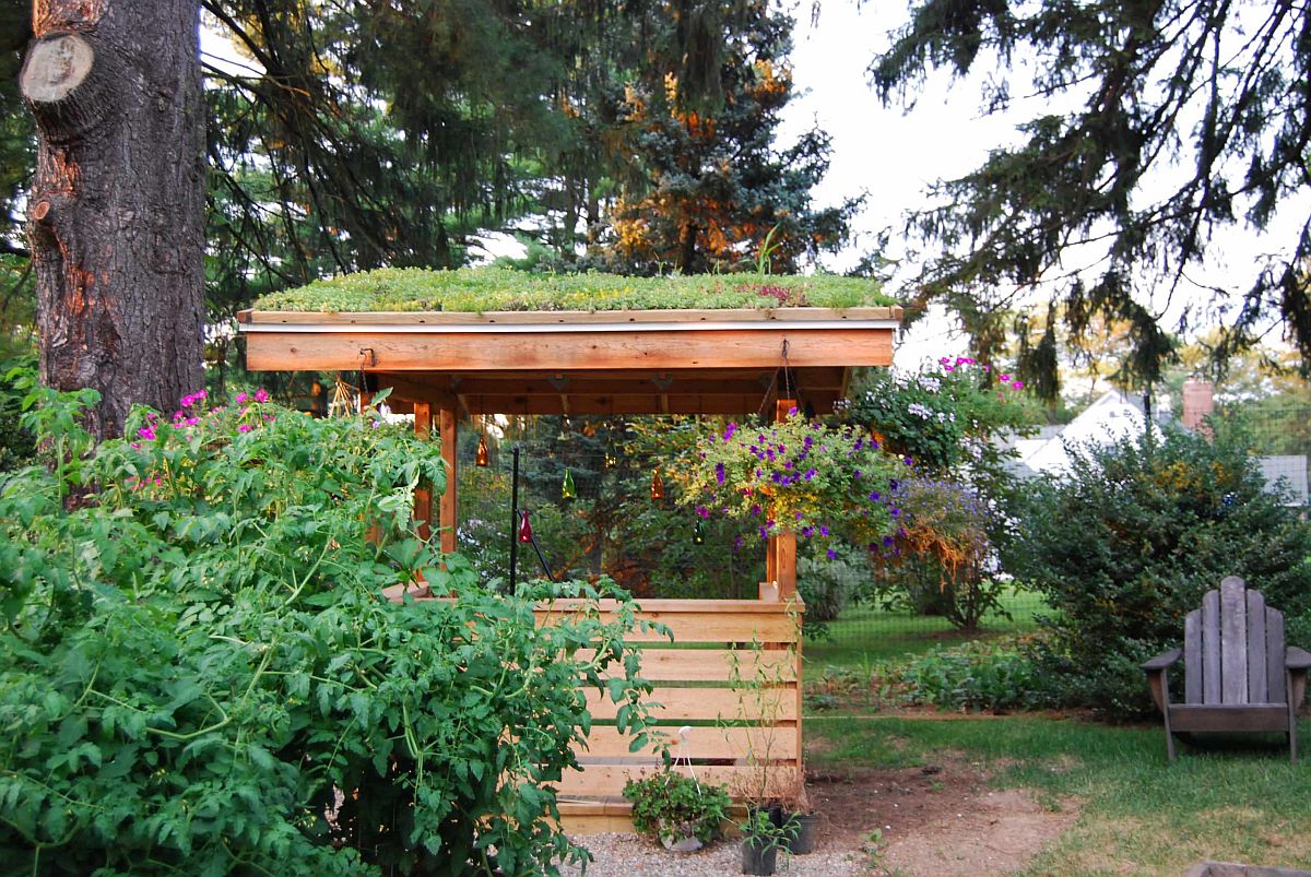 Pergola covered in greenery provides a calm refuge in the nature-filled backyard