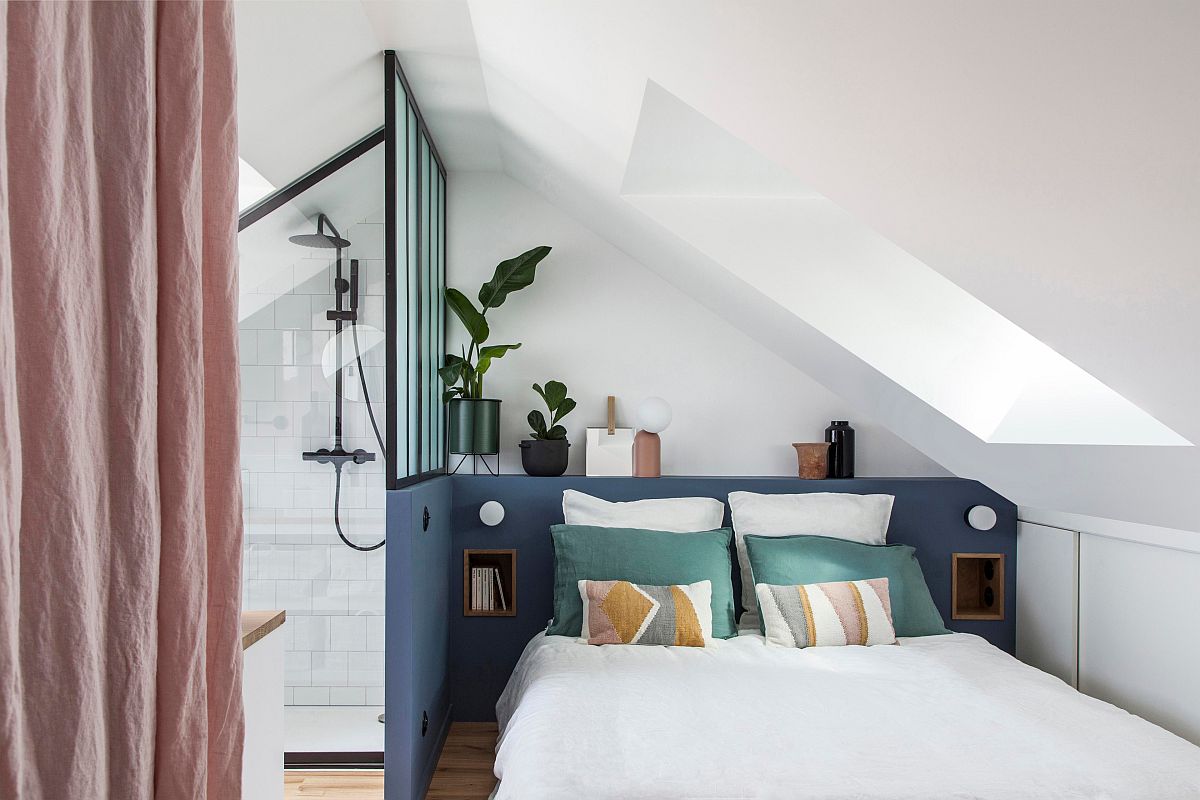 Smart color blocks bring visual contrast to this tiny white bedroom with bathroom next to it