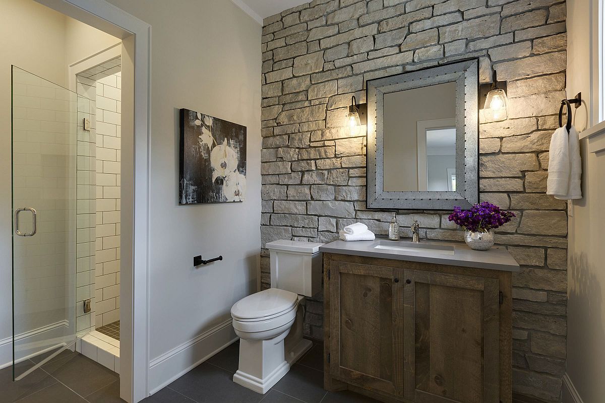 Stone wall in the modern farmhouse bathroom steals the show instantly