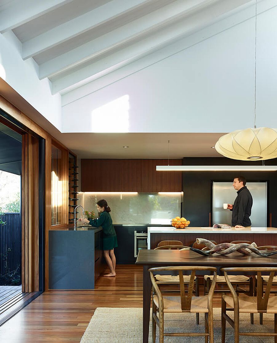 Wood, white and shades of gray shape the new kitchen and dining area inside this modern home