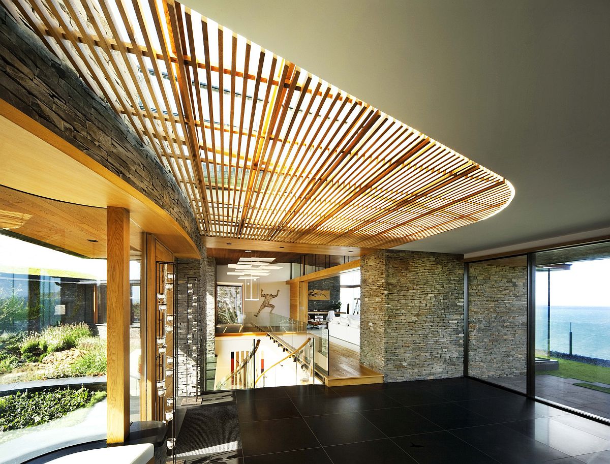 Wooden slats filter natural light into this expansive coastal home