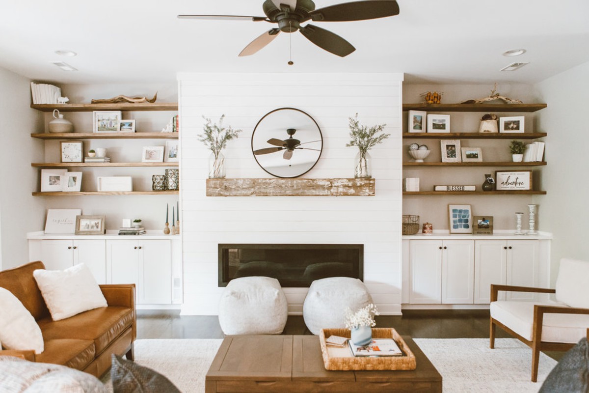 white living room with brown furniture and wooden accents