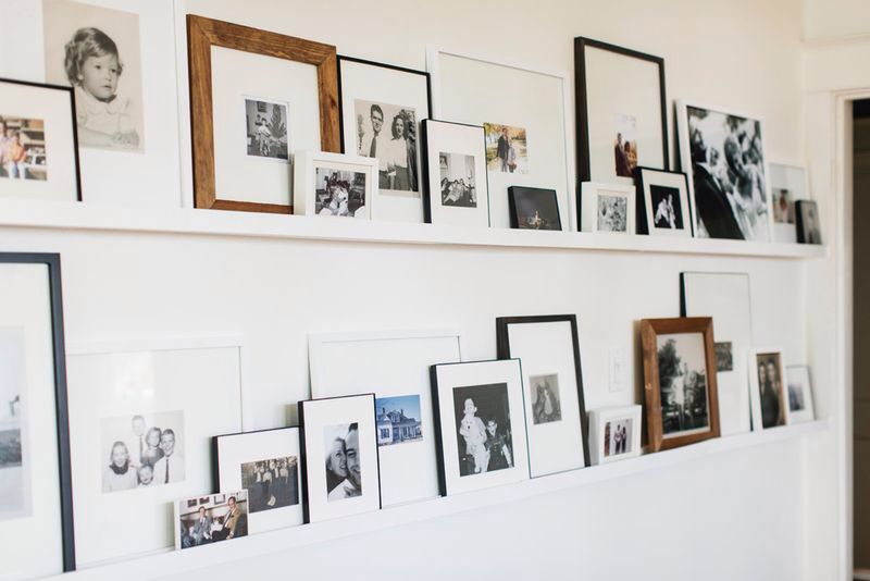 a gallery wall displayed on ledges rather than hung up