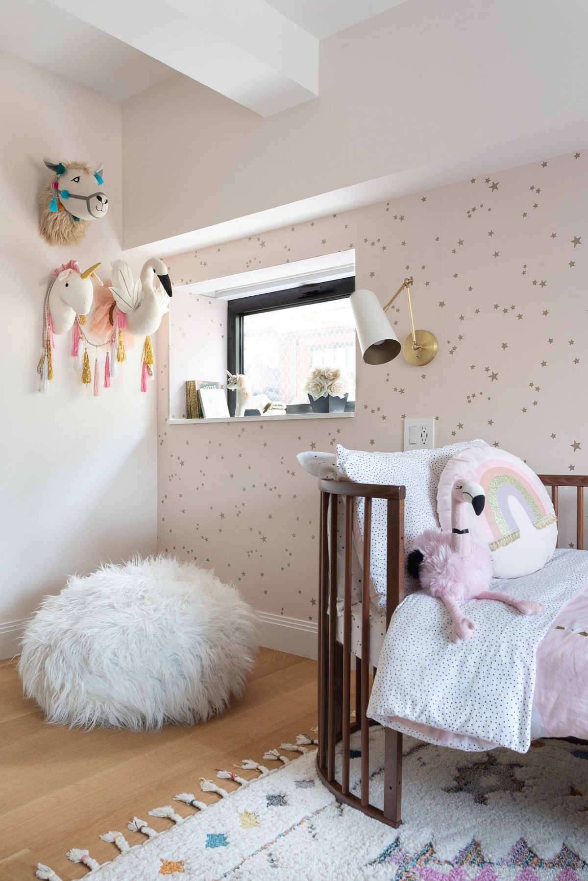 Chic kids' berdoom of New York home with elegant wallpaper and a dash of muted pink