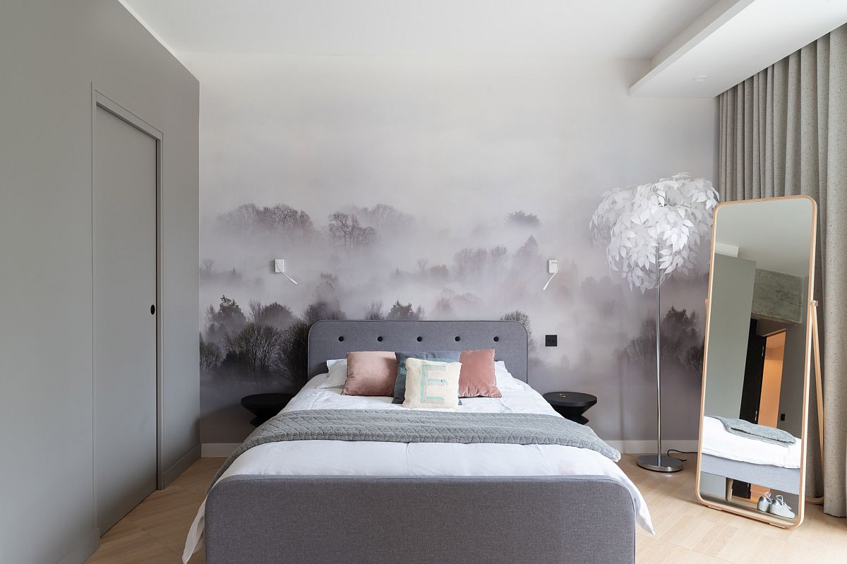 Fabulous mural in the backdrop steals the show in this lovely little Scandinavian style bedroom with gray bed and drapes