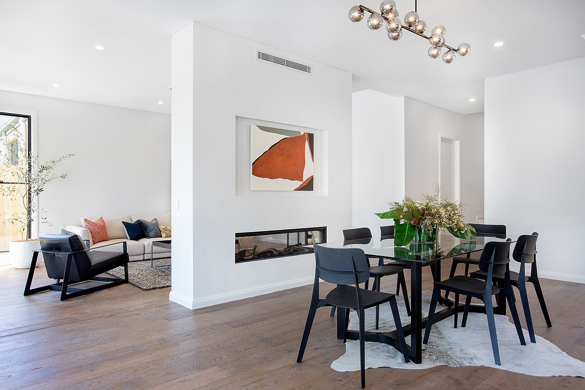 Fireplace wall delineates the living area from the dining room in here